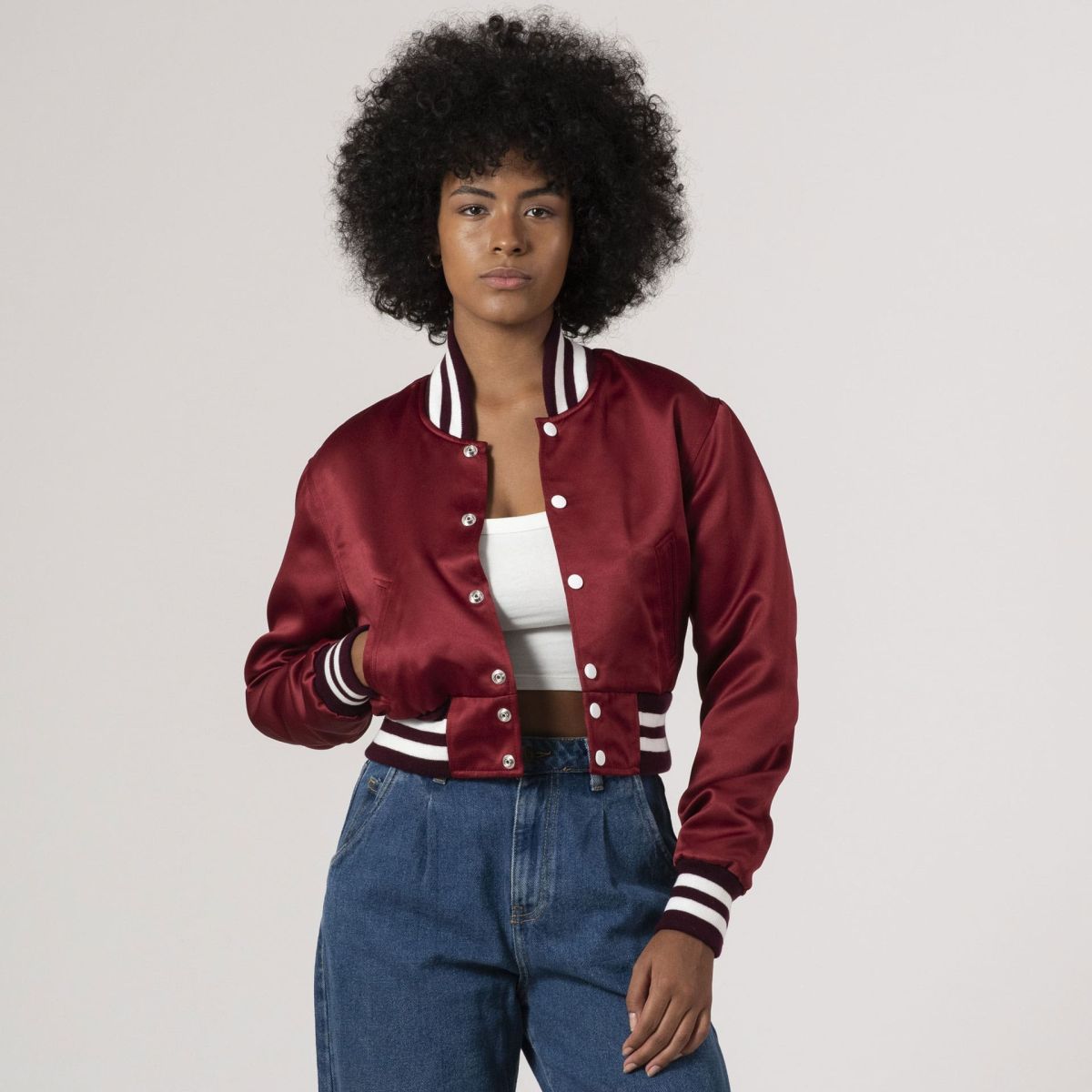 Maroon satin crop top varsity jacket with a sleek, sporty design, perfect for modern streetwear.