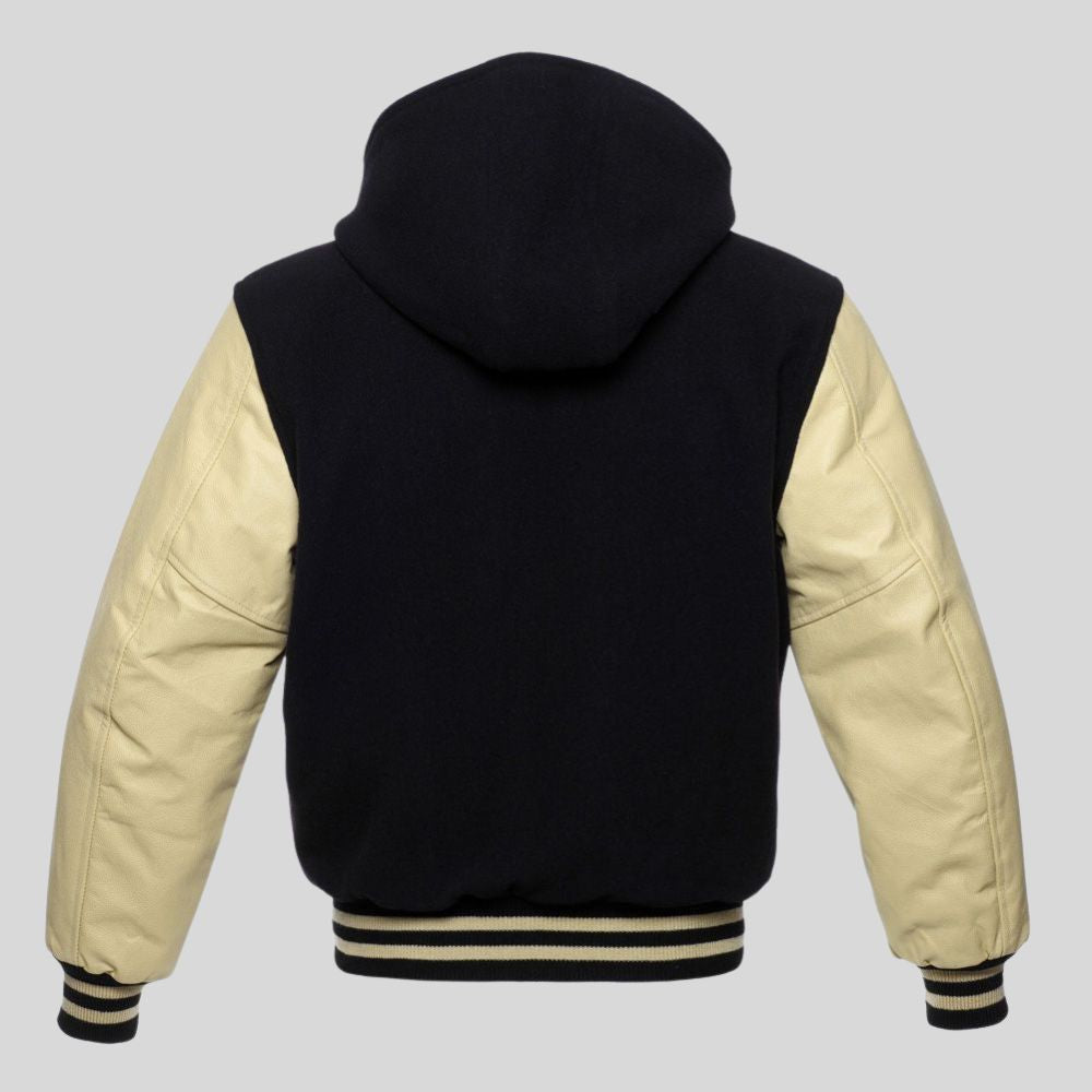 Black and cream varsity jacket with a hood on a gray background