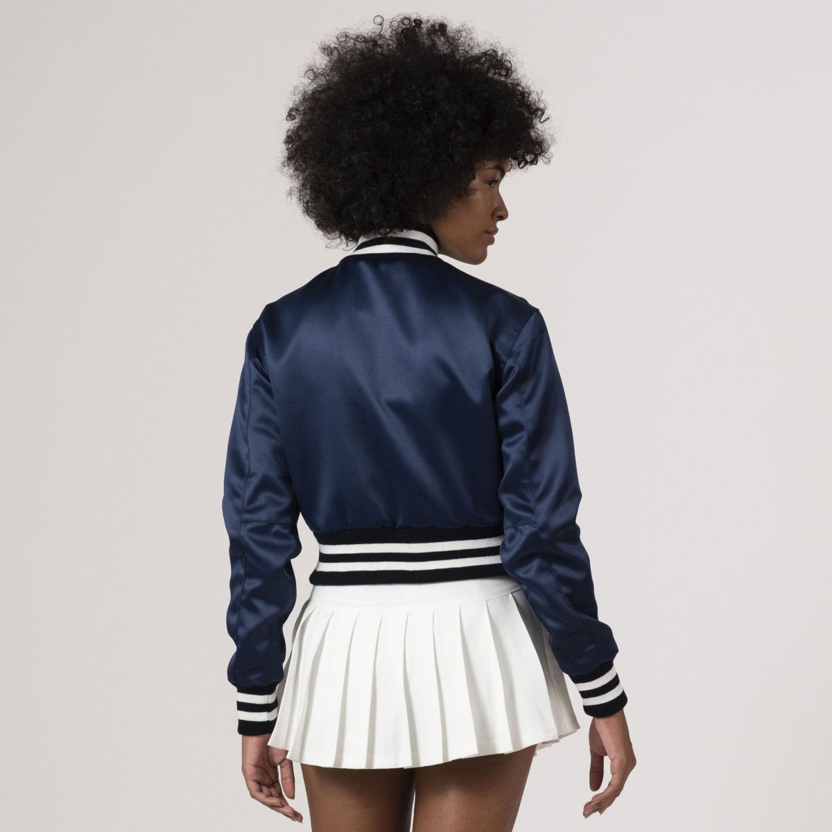 Chic navy blue satin varsity jacket with a cropped design, perfect for a trendy and sporty aesthetic