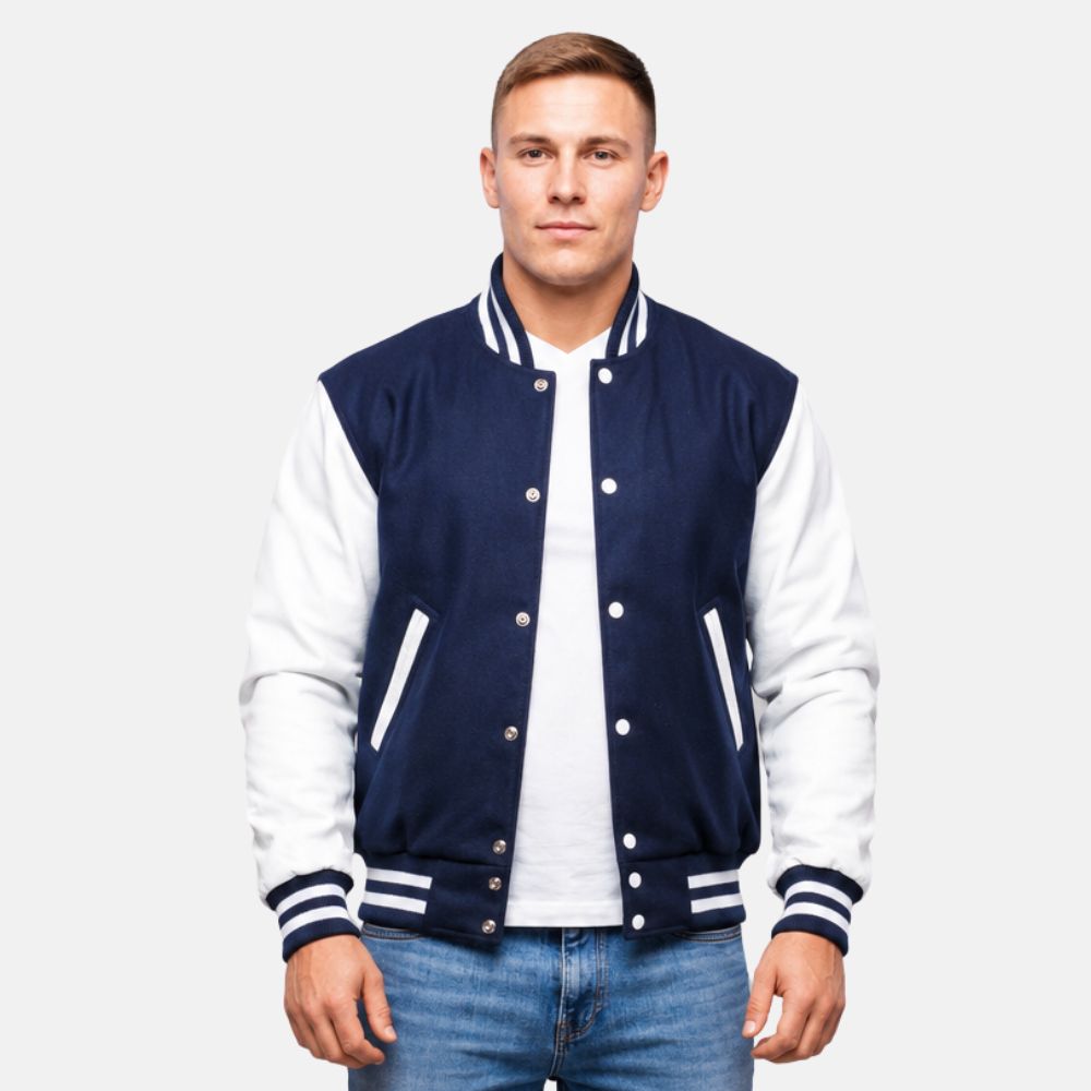 Man wearing a navy and white varsity jacket on a plain background