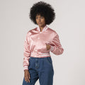 Fashionable pink crop top varsity jacket in satin, combining elegance with athletic style