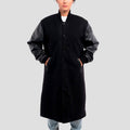 Stylish black wool varsity coat with sleek leather sleeves, perfect for a refined, sporty appearance