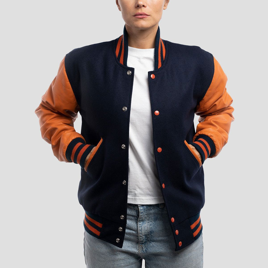 Royal blue wool letterman jacket with vibrant orange leather sleeves, combining classic style with a bold twist