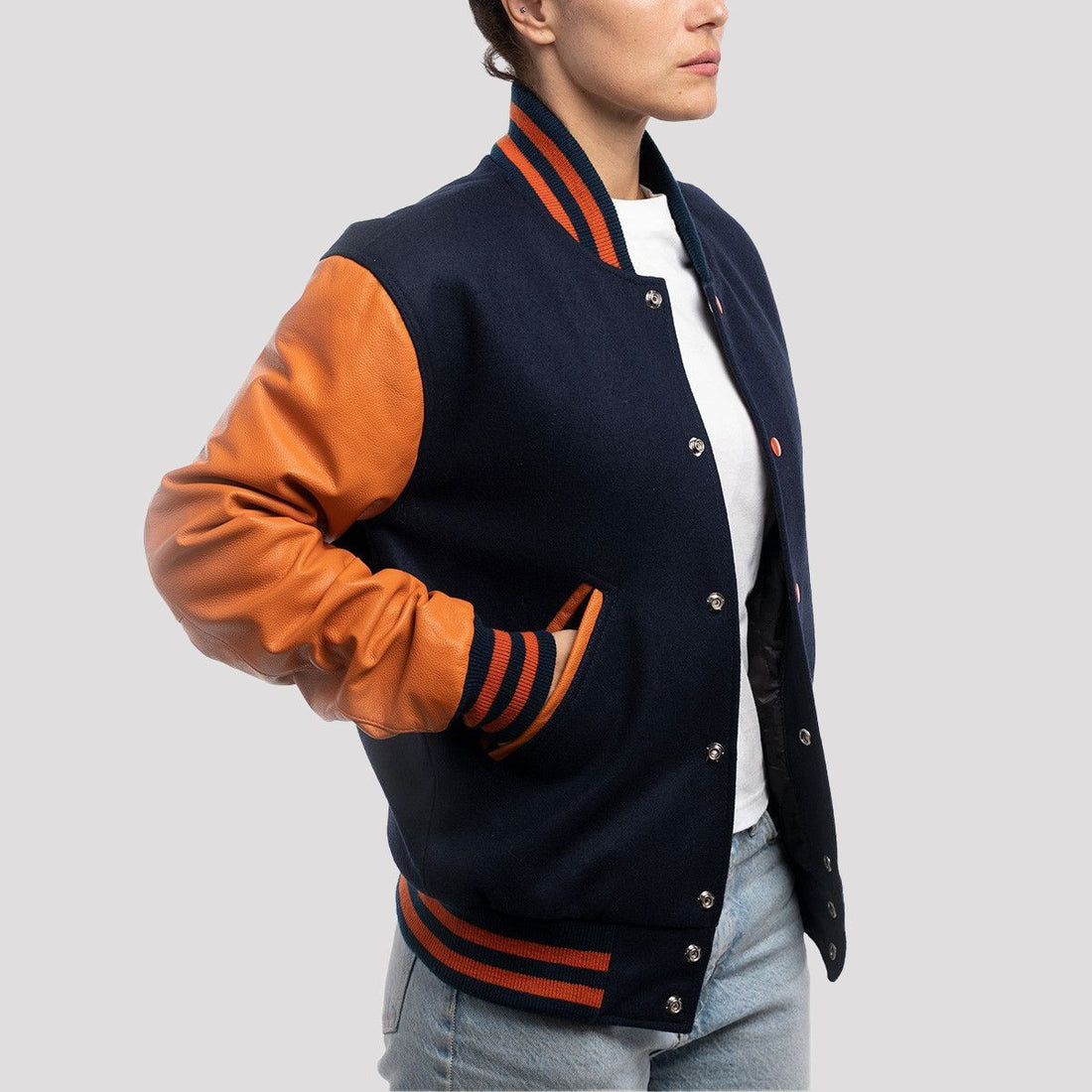 Royal blue wool letterman jacket with vibrant orange leather sleeves, combining classic style with a bold twist