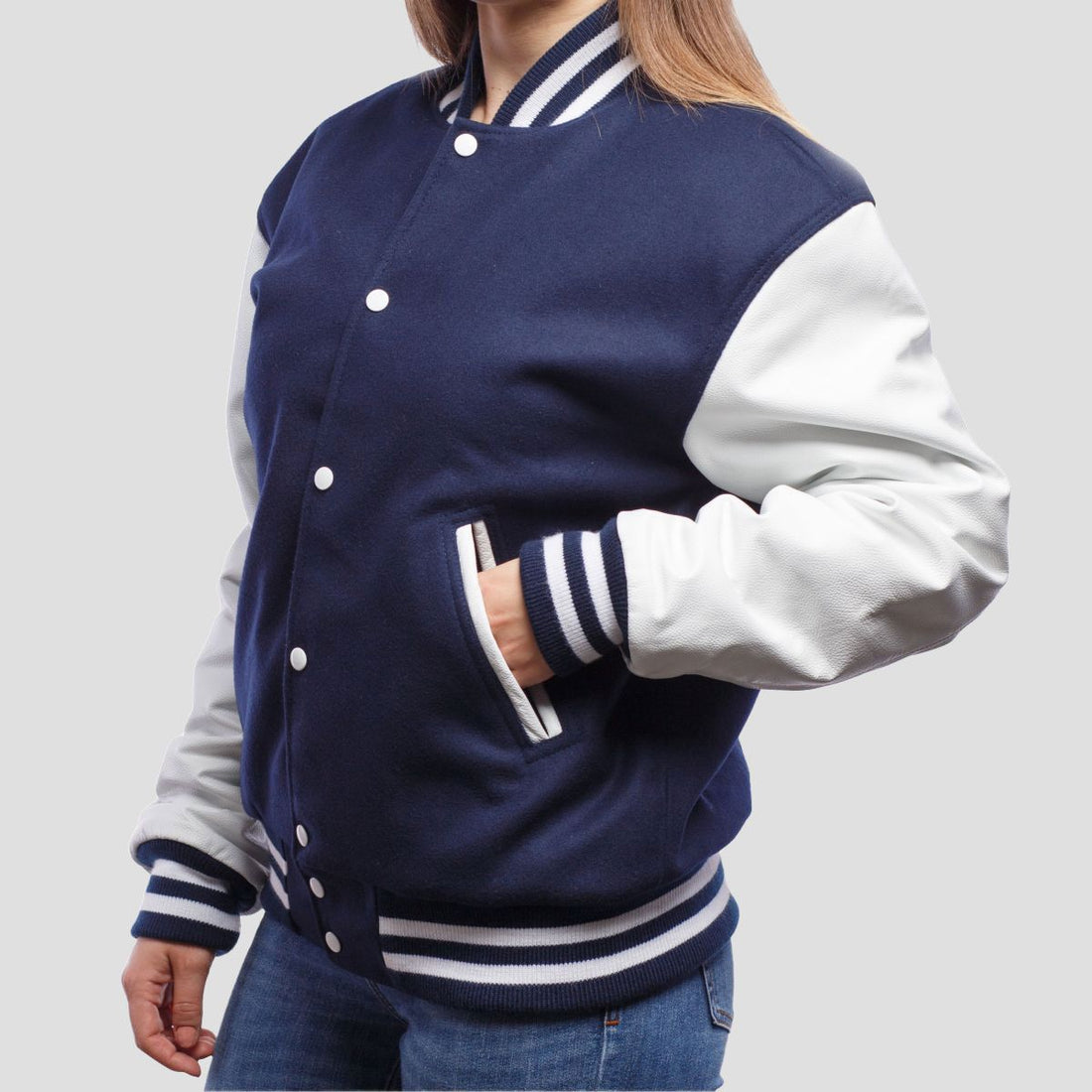 Royal blue wool letterman jacket featuring white leather sleeves, combining classic varsity style with modern elegance