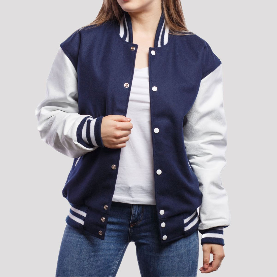 Royal blue wool letterman jacket featuring white leather sleeves, combining classic varsity style with modern elegance