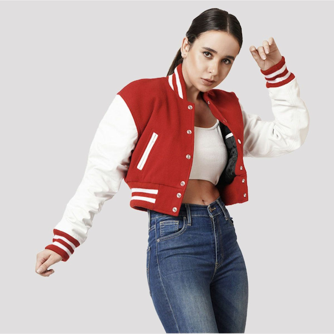 Scarlet red crop top varsity jacket with white leather sleeves, offering a vibrant and sporty look