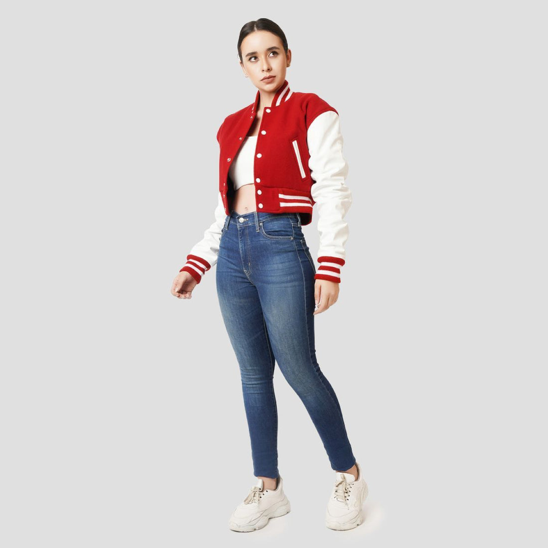 Scarlet red crop top varsity jacket with white leather sleeves, offering a vibrant and sporty look