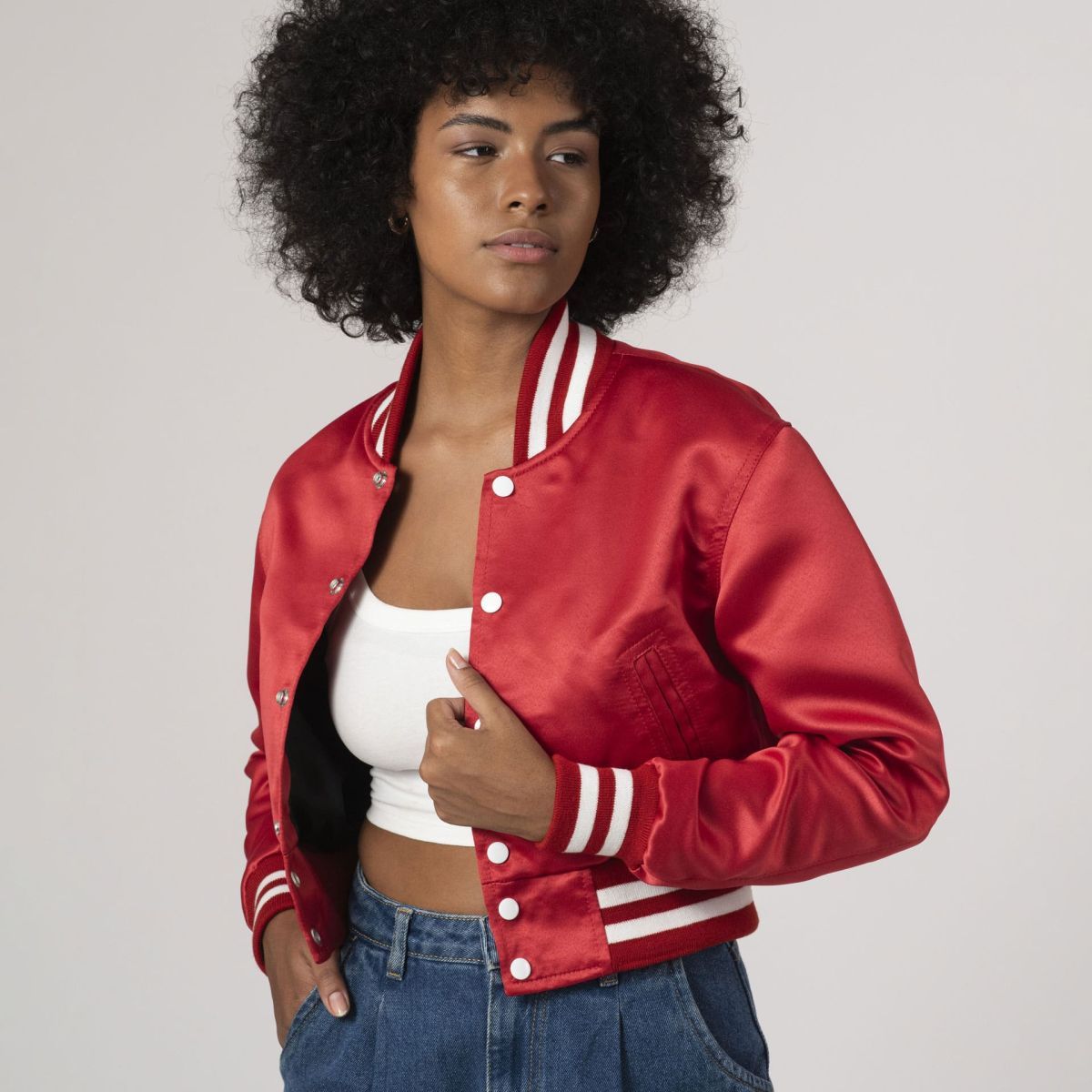 Fashionable scarlet red crop top varsity jacket in satin, combining luxury with an athletic vibe