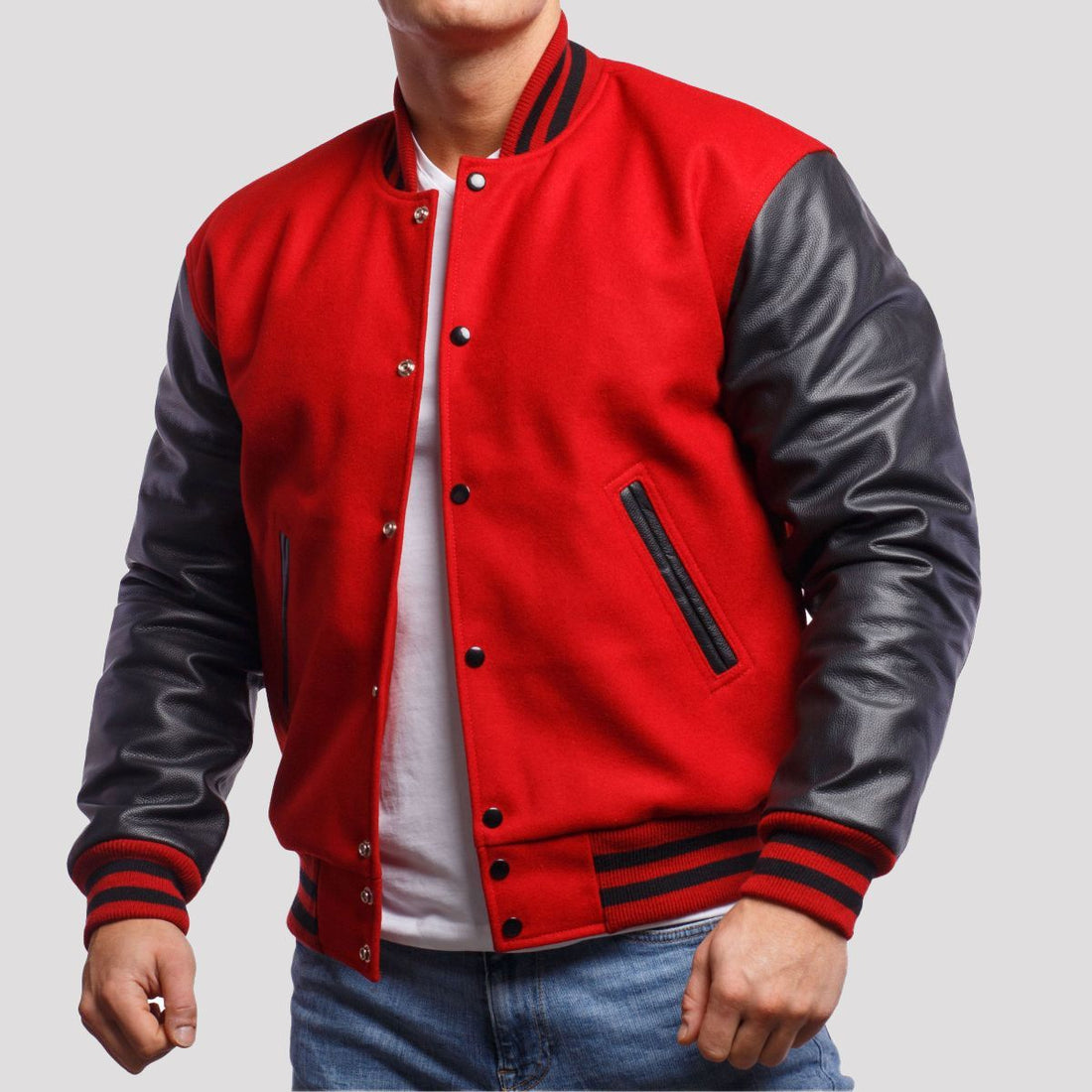 Scarlet red wool letterman jacket featuring black leather sleeves, blending classic style with a modern edge