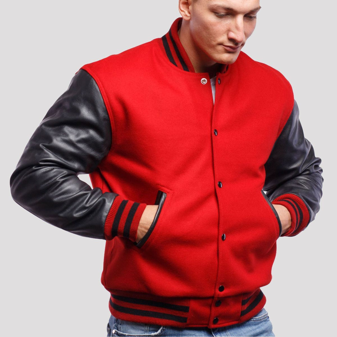 Scarlet red wool letterman jacket featuring black leather sleeves, blending classic style with a modern edge