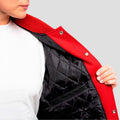 Fashionable scarlet red wool letterman coat featuring luxurious black leather sleeves, perfect for chilly weather.