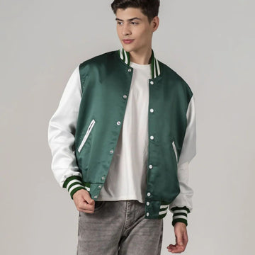 A male model wearing a Kelly green satin varsity jacket with white sleeves and a white collar, standing against a plain background.